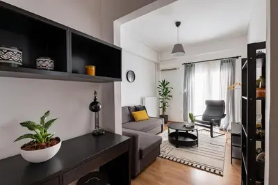 a living room with a couch and a table at Urban Chic Hideaway Near Athens Center & Metro in Athens