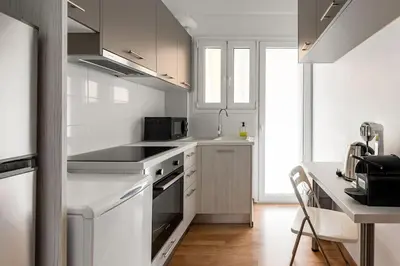 a kitchen with white cabinets and a stove top oven at Urban Chic Hideaway Near Athens Center & Metro in Athens