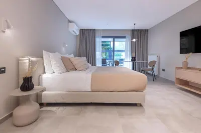 a bedroom with a bed and a living room at Phaedrus Living Athens Luxury Residences Aurora in Athens