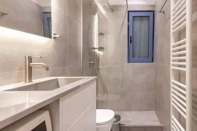 a bathroom with a sink and a toilet and a shower at Phaedrus Living Athens Luxury Residences Aurora in Athens