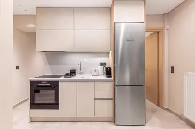 a kitchen with a stainless steel refrigerator at Phaedrus Living Athens Luxury Residences Aurora in Athens