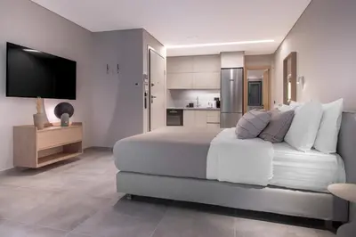 a bedroom with a large bed and a kitchen at Phaedrus Living Athens Luxury Residences Aurora in Athens