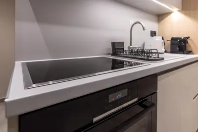a kitchen with a sink and a stove top oven at Phaedrus Living Athens Luxury Residences Aurora in Athens