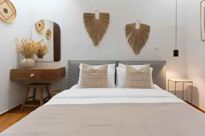 a bedroom with a bed with wings on the wall at Phaedrus Living Kolonaki Maple Residence in Athens