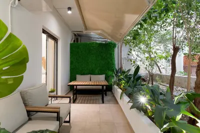 an outdoor patio with plants and a table at Phaedrus Living Kolonaki Maple Residence in Athens