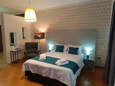 a bedroom with a large bed with towels on it at Plaka Hideaway Suite in Athens