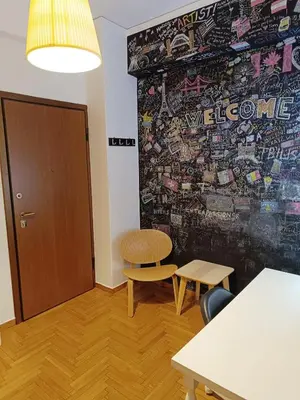 a room with a wall with a bench and a chair at Plaka Hideaway Suite in Athens