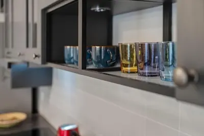 a row of glasses on a shelf in a kitchen at Athens Lycabettus hill, 2 bd apt- Apokafkon in Athens