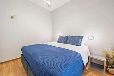 a bedroom with a bed with blue and white sheets at Athens Lycabettus hill, 2 bd apt- Apokafkon in Athens