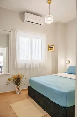 a bedroom with a blue bed and a window at Athens Lycabettus hill, 2 bd apt- Apokafkon in Athens