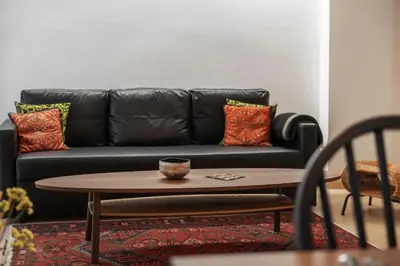 a living room with a black couch and a coffee table at Athens Lycabettus hill, 2 bd apt- Apokafkon in Athens