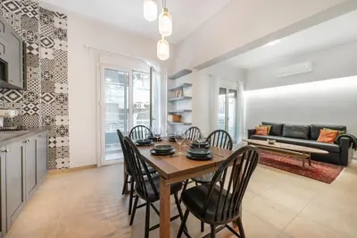 a kitchen and dining room with a table and chairs at Athens Lycabettus hill, 2 bd apt- Apokafkon in Athens