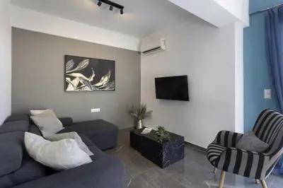 a living room with a couch and two chairs at Modern Renovated Apartment in Metaksourgio in Athens