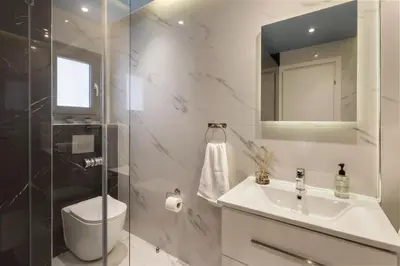 a bathroom with a toilet and a sink and a shower at Modern Renovated Apartment in Metaksourgio in Athens