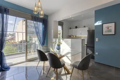 a kitchen and dining room with a glass table and chairs at Modern Renovated Apartment in Metaksourgio in Athens