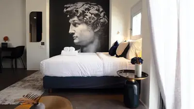 a bedroom with a bed with a painting of a woman at The Solon House-Self check-in in Athens