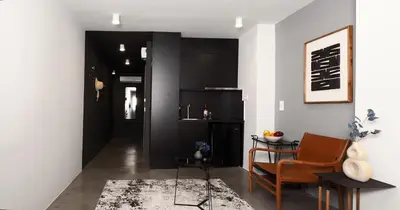 a living room with a table and a chair at The Solon House-Self check-in in Athens