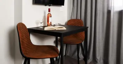 a black table with two chairs and a bottle of wine at The Solon House-Self check-in in Athens