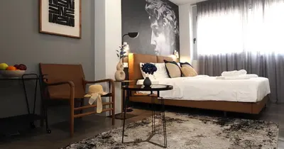 a bedroom with a bed and a chair and a table at The Solon House-Self check-in in Athens