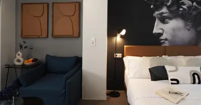 a bedroom with a bed and a blue chair at The Solon House-Self check-in in Athens
