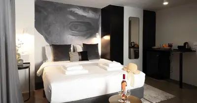 a bedroom with a bed with a picture of an eye at The Solon House-Self check-in in Athens