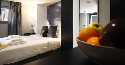 a room with a bed with a bowl of fruit on a table at The Solon House-Self check-in in Athens
