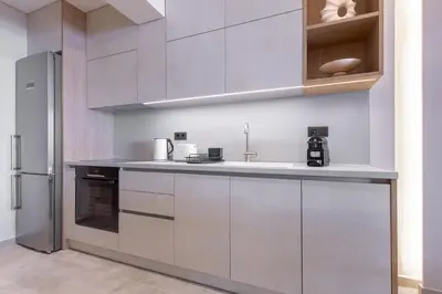 a kitchen with white cabinets and a stainless steel refrigerator at Phaedrus Living Athens Luxury Residences Champagne in Athens