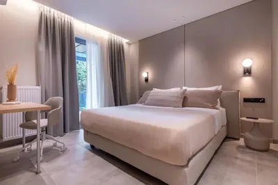 a bedroom with a bed and a table and a desk at Phaedrus Living Athens Luxury Residences Champagne in Athens
