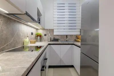 a kitchen with white cabinets and a sink at Koukaki Cielo Villa10 -Pvt Yard 3BR 8ppl -10min Metro Acropolis in Athens