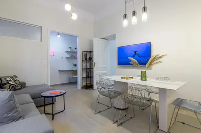 a living room with a couch and a table at Koukaki Cielo Villa10 -Pvt Yard 3BR 8ppl -10min Metro Acropolis in Athens