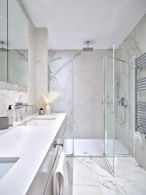 a white bathroom with two sinks and a shower at 20nty Kolonaki in Athens