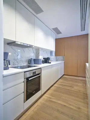 a kitchen with white appliances and wooden cabinets at 20nty Kolonaki in Athens