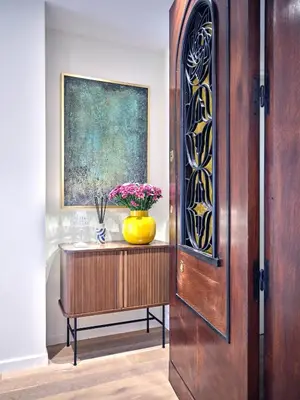 a wooden door with a vase of flowers on a table at 20nty Kolonaki in Athens