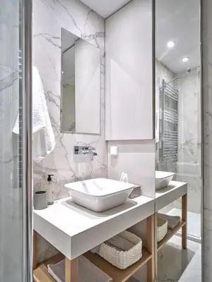 a white bathroom with a sink and a mirror at 20nty Kolonaki in Athens