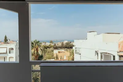 a view of a city from a window at Grand Sea View Apartment 3' from Kavouri Beach in Athens