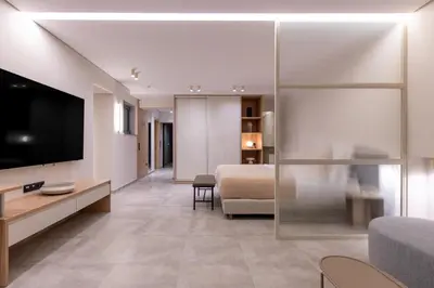 a living room with a bed and a television at Phaedrus Living Athens Luxury Residences Beige in Athens