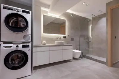 a bathroom with a washer and a sink and a washing machine at Phaedrus Living Athens Luxury Residences Beige in Athens