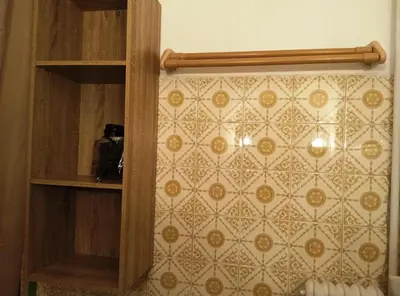 a room with a wall with a patterned wall at 1970s Athenean Apartment in Athens
