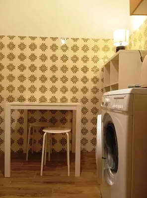 a kitchen with a table and a washing machine at 1970s Athenean Apartment in Athens