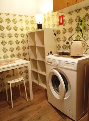a laundry room with a washing machine and a table at 1970s Athenean Apartment in Athens