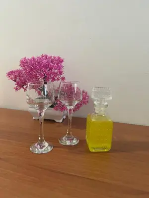 three wine glasses and a bottle of mustard on a table at Cozy Mezonette near City Center Athens near Metro in Athens