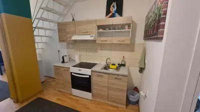 a small kitchen with a sink and a stove at Cozy Mezonette near City Center Athens near Metro in Athens