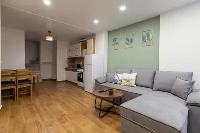 a living room with a couch and a table at Entire Apt, Maisonette, 1 Bedroom in Athens