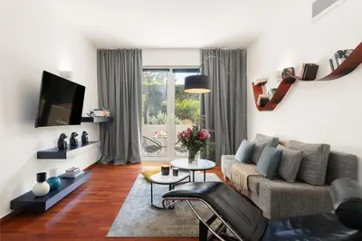 a living room with a couch and a tv at Serena Calm Pool House in Athens