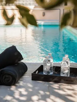 two bottles of water sitting on a tray next to a pool at Serena Calm Pool House in Athens