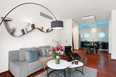 a living room with a couch and a table with flowers at Serena Calm Pool House in Athens