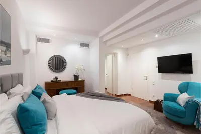a bedroom with a bed and two blue chairs at Serena Calm Pool House in Athens