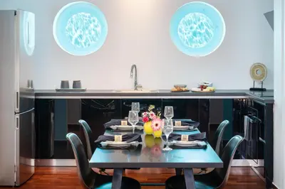 a table in a kitchen with a blue table and chairs at Serena Calm Pool House in Athens