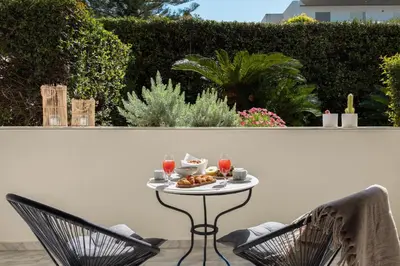 a table with a plate of food and two chairs at Serena Calm Pool House in Athens