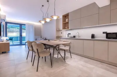 a kitchen and dining room with a table and chairs at Phaedrus Living Athens Luxury Residences Golden in Athens